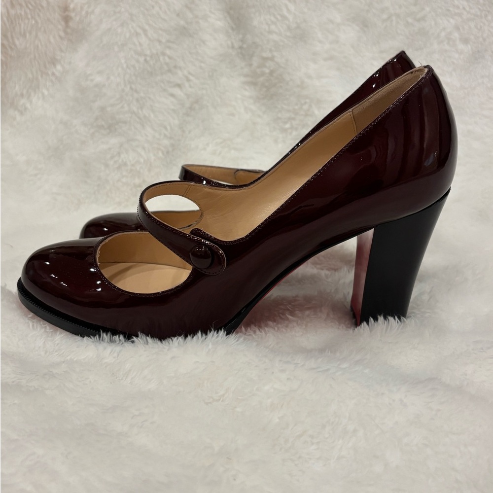 Louboutin red Mary Jane pumps.